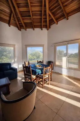 a living room with a table and a couch at CABAÑA MAR - FINCA PUDUAM in Villa General Belgrano