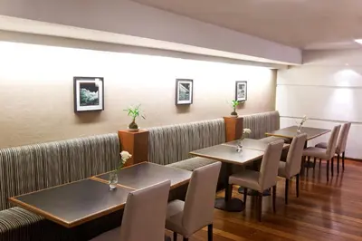 a restaurant with tables and chairs in a room at NH Córdoba Panorama in Cordoba