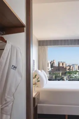 a hotel room with a bed and a window at NH Córdoba Panorama in Cordoba