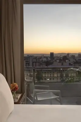 a bedroom with a view of a city skyline at NH Córdoba Panorama in Cordoba