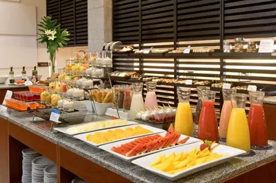 a buffet with many different types of food and drinks at NH Córdoba Panorama in Cordoba