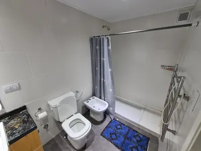 a small bathroom with a toilet and a shower at Dpto The View, Puerto del Águila Lago Los Molinos in Potrero de Garay
