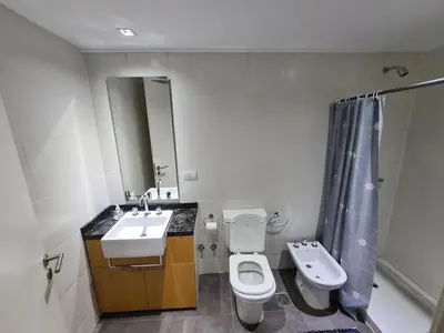 a bathroom with a sink and a toilet and a mirror at Dpto The View, Puerto del Águila Lago Los Molinos in Potrero de Garay