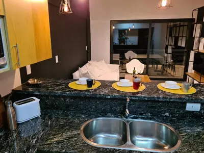 a kitchen with a sink and two plates on a counter at Dpto The View, Puerto del Águila Lago Los Molinos in Potrero de Garay
