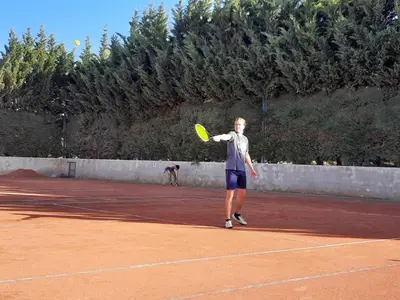 a man holding a tennis racket on a tennis court at Dpto The View, Puerto del Águila Lago Los Molinos in Potrero de Garay