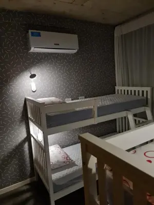 a bedroom with two bunk beds and a ceiling at Dpto The View, Puerto del Águila Lago Los Molinos in Potrero de Garay