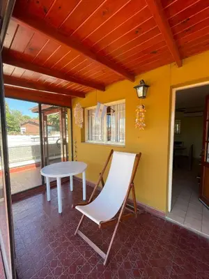 a room with a table and a chair on a patio at terrazas del Tajamar in Alta Gracia