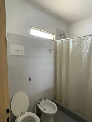 a bathroom with a toilet and a shower at terrazas del Tajamar in Alta Gracia