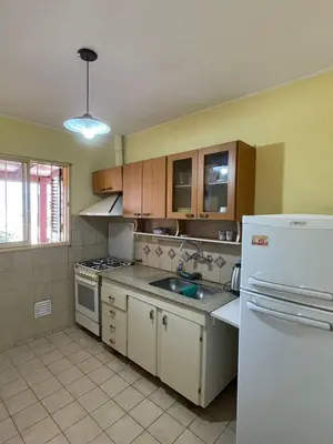 a kitchen with a white refrigerator and a sink at terrazas del Tajamar in Alta Gracia