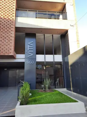 a building with a sign on the side of it at APART VITTA in Río Cuarto