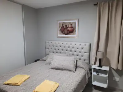 a bedroom with a bed with two towels on it at APART VITTA in Río Cuarto