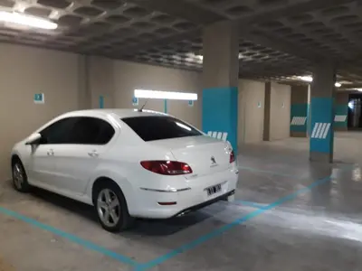 a white car parked in a parking lot at APART VITTA in Río Cuarto