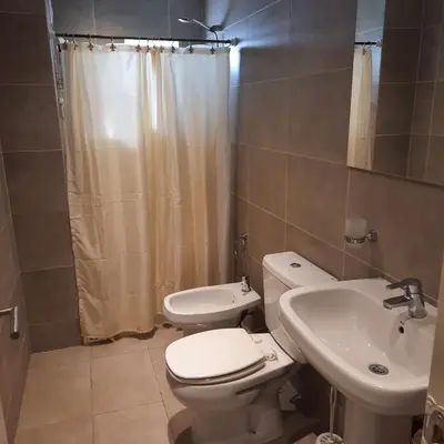 a bathroom with a toilet and a sink at APART VITTA in Río Cuarto