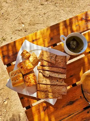 a plate of food with bread and a cup of coffee at Los Molles Suites -Solo 2 Pax- in Mina Clavero