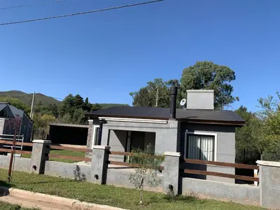 a small house with a fence around it at Cabaña Siete Colores II in Santa Rosa de Calamuchita