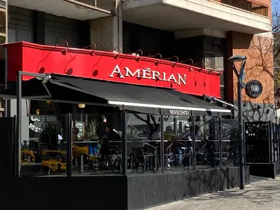 a restaurant with tables and chairs in front of a building at Amérian Córdoba in Cordoba