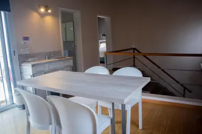 a kitchen with a white table and white chairs at LA AMISTAD-CIUDAD UNIVERSITARIA- HOSPITAL FERREYRA in Cordoba
