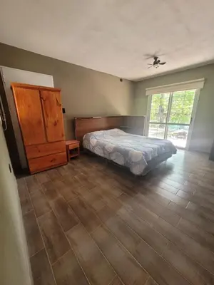 a bedroom with a bed and a dresser and a window at Casa Tio Molina in Bialet Massé