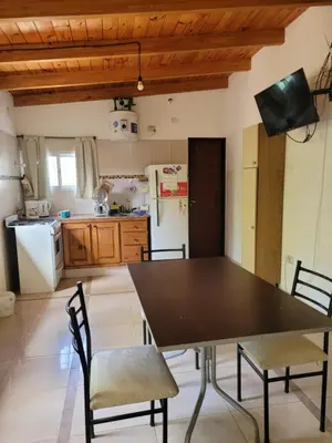 a kitchen with a table and chairs and a refrigerator at Casa Tio Molina in Bialet Massé