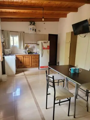 a kitchen with a table and chairs and a refrigerator at Casa Tio Molina in Bialet Massé