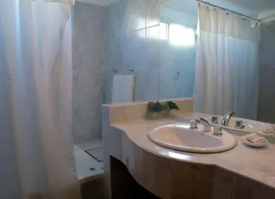 a bathroom with a sink and a shower at BAHIA DEL LAGO in Villa Carlos Paz