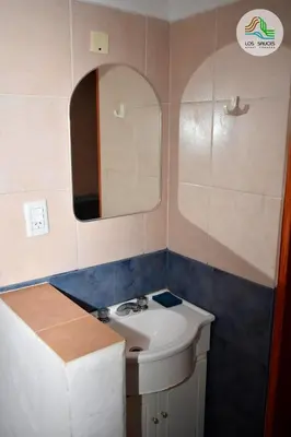 a bathroom with a sink and a mirror at APART CABAÑAS LOS SAUCES in Tanti