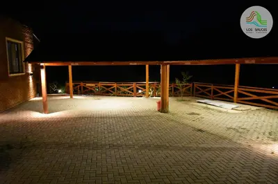 a night view of a building with a pavilion at APART CABAÑAS LOS SAUCES in Tanti