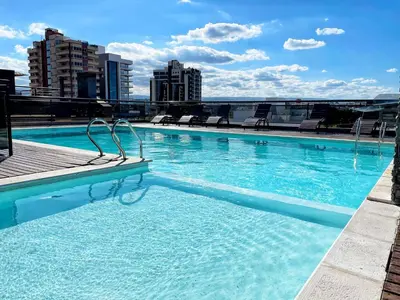 a swimming pool on the roof of a building at Departamentos Miralejos 6 in Villa Carlos Paz