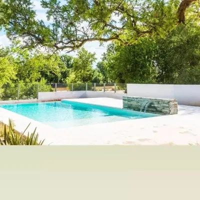 a swimming pool in the middle of a yard at Favre Suites in Mina Clavero