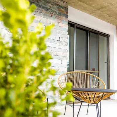 a table and a chair on a patio at Favre Suites in Mina Clavero