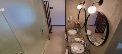 a bathroom with two sinks and a mirror at Favre Suites in Mina Clavero
