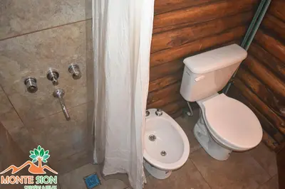 a bathroom with a toilet and a shower at Monte Sion cabañas & relax in San Javier