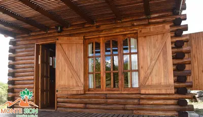a log cabin with a door and windows at Monte Sion cabañas & relax in San Javier