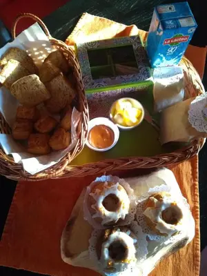 a table with a basket of food on a table at Cabañas Tierra del Sol in Las Rabonas