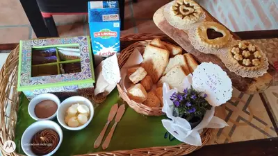 a basket of bread and other food on a table at Cabañas Tierra del Sol in Las Rabonas