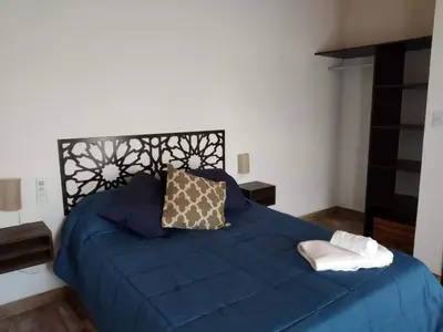 a blue bed with two pillows on top of it at Cabañas Tierra del Sol in Las Rabonas