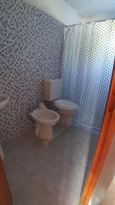 a bathroom with two toilets and a sink at Susurro de Montaña in San Lorenzo