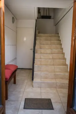 a stairway with a red bench and a stair case at Dpto s/av Rafael Nuñez - 1 dorm y balcon in Cordoba