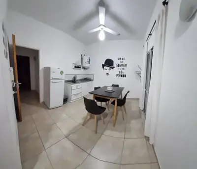 a kitchen with a table and chairs and a refrigerator at Dpto s/av Rafael Nuñez - 1 dorm y balcon in Cordoba
