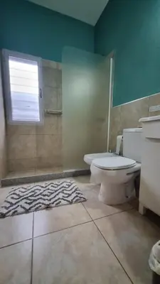 a bathroom with a toilet and a shower and a window at Dpto s/av Rafael Nuñez - 1 dorm y balcon in Cordoba