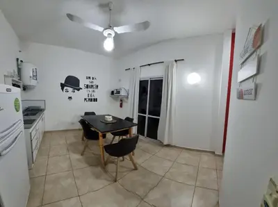a small kitchen with a table and a refrigerator at Dpto s/av Rafael Nuñez - 1 dorm y balcon in Cordoba