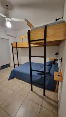 a bunk bed in a room with a blue bed at Dpto s/av Rafael Nuñez - 1 dorm y balcon in Cordoba