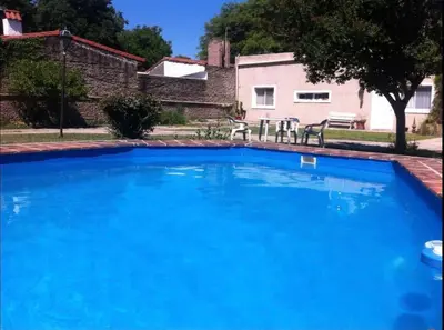 a large blue swimming pool in front of a house at RELÁJATE Y DISFRUTA DE LA MEJOR ZONA DE CORDOBA. in Cordoba