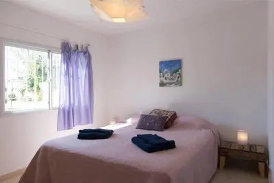 a bedroom with a bed with two blue pillows on it at RELÁJATE Y DISFRUTA DE LA MEJOR ZONA DE CORDOBA. in Cordoba