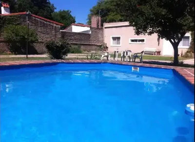 a large blue swimming pool in front of a house at RELÁJATE Y DISFRUTA DE LA MEJOR ZONA DE CORDOBA. in Cordoba