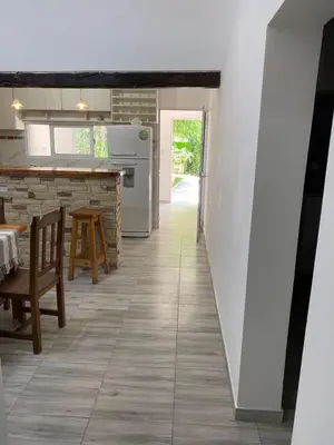 a kitchen and dining room with a table and chairs at Abdulle Complejo Turistico Centro in Villa Cura Brochero