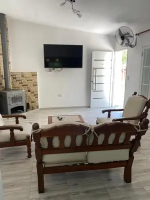 a living room with a couch and two chairs at Abdulle Complejo Turistico Centro in Villa Cura Brochero