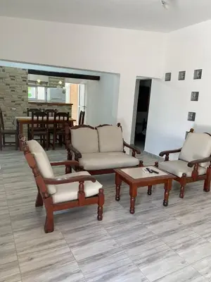 a living room with two chairs and a coffee table at Abdulle Complejo Turistico Centro in Villa Cura Brochero