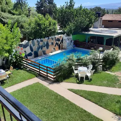 a swimming pool in the backyard of a house at Abdulle Complejo Turistico Centro in Villa Cura Brochero