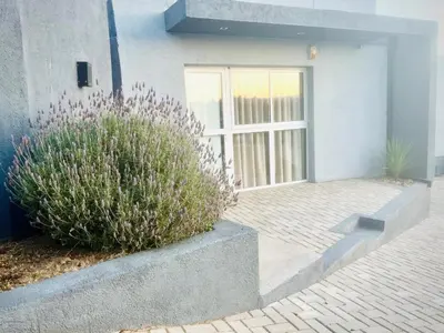 a front door of a house with a plant at Depto en la Sierra!! Barrio Villa del Lago con vista a los Gigantes in Villa Carlos Paz